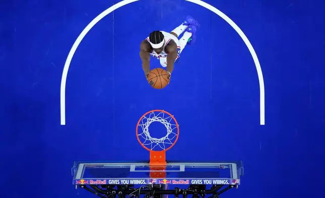 Philadelphia 76ers' VJ Edgecombe goes up for a dunk during the first half of a preseason NBA basketball game against the New York Knicks Monday, Oct. 5, 2026, in Philadelphia. (AP Photo/Matt Slocum)