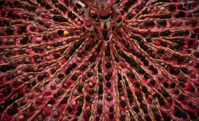 Members of Castellers Colla Vella form a "castell," or human tower, during the 30th Concurs de Castells, or Human Tower Competition, in Tarragona, Spain, Sunday, Oct. 4, 2026. (AP Photo/Emilio Morenatti)