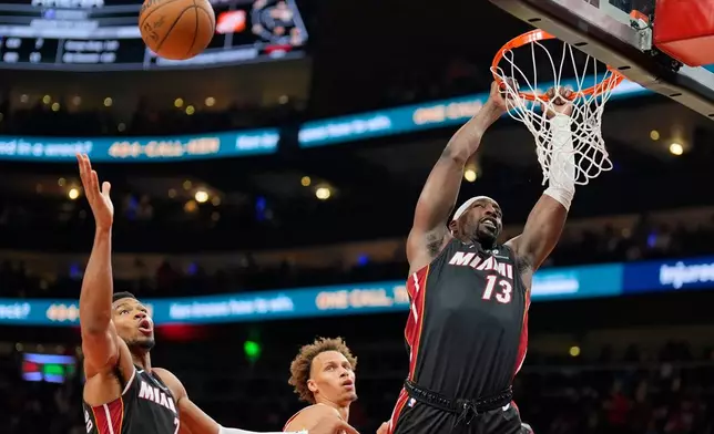 Miami Heat center Bam Adebayo (13) shoots against Atlanta Hawks guard Dyson Daniels (5) during the second half of an NBA basketball game, Wednesday, Oct. 28, 2026, in Atlanta. (AP Photo/Mike Stewart)