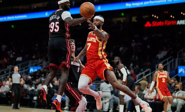 Atlanta Hawks guard Nickeil Alexander-Walker (7) passes ahainst Miami Heat forward Bobby Portis (95) during the first half of an NBA basketball game, Wednesday, Oct. 28, 2026, in Atlanta. (AP Photo/Mike Stewart)