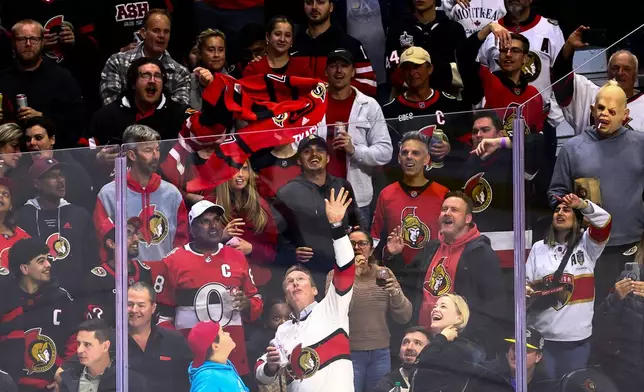Fans throw a former Ottawa Senators Brady Tkachuk jersey onto the ice during an NHL hockey game between the Florida Panthers and the Ottawa Senators in Ottawa, on Wednesday, Oct. 21, 2026. (Keito Newman/The Canadian Press via AP)