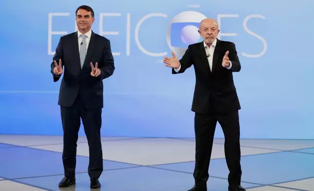 Brazilian President Luiz Inacio Lula da Silva, right, who is running for reelection, and opposition presidential candidate Sen. Flavio Bolsonaro attend a televised presidential debate days before the presidential runoff election in Rio de Janeiro, Friday, Oct. 23, 2026. (AP Photo/Bruna Prado)