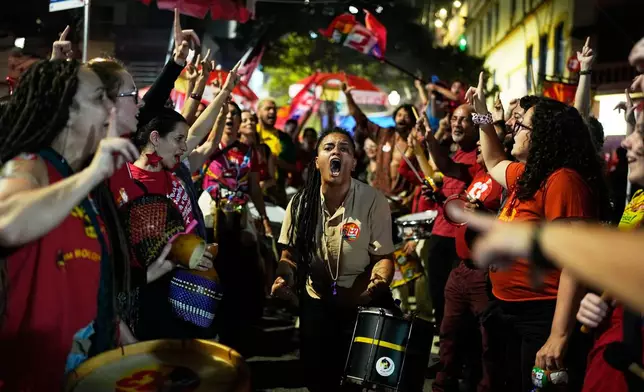 Supporters of Brazilian President Luiz Inacio Lula da Silva, who is seeking reelection, shout slogans before a televised presidential debate between Lula and his rival, Sen. Flavio Bolsonaro, days before the presidential runoff election in Sao Paulo, Friday, Oct. 23, 2026. (AP Photo/Natacha Pisarenko)