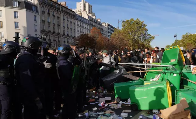 Riot police face high school students as they gather before a demonstration against under-resourced schools in Paris, Tuesday, Oct. 6, 2026. (AP Photo/Aurelien Morissard)