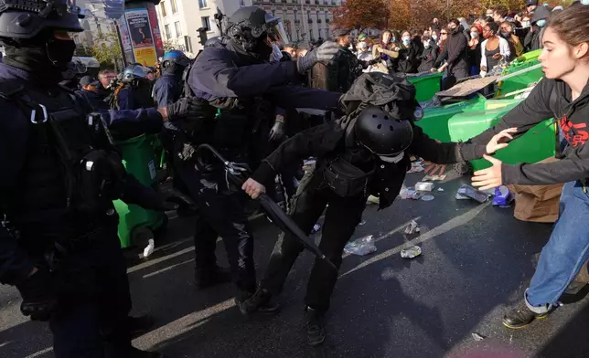 Riot police face high school students as they gather before a demonstration against under-resourced schools in Paris, Tuesday, Oct. 6, 2026. (AP Photo/Aurelien Morissard)