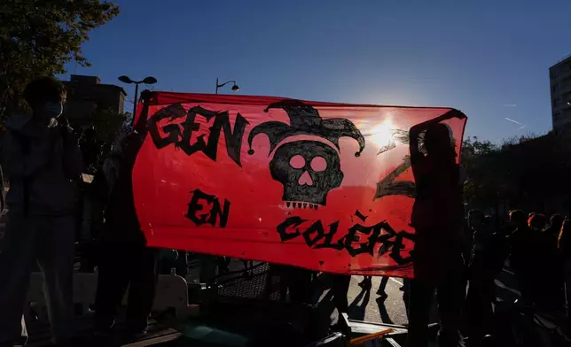 Students hold a banner reading "Youth in anger" as they gather before a demonstration against under-resourced schools, in Paris, Tuesday, Oct. 6, 2026. (AP Photo/Aurelien Morissard)