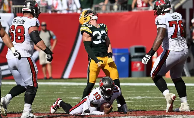Green Bay Packers safety Evan Williams (33) celebrates after sacking Tampa Bay Buccaneers quarterback Jalon Daniels (10) during the second half an NFL football game in Tampa, Fla., Sunday, Oct. 4, 2026. (AP Photo/Jason Behnken)