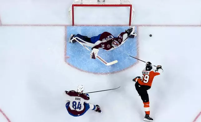 Philadelphia Flyers' Matvei Michkov (39) cannot get a shot past Colorado Avalanche's Mackenzie Blackwood (39) and Brent Burns (84) during the second period of an NHL hockey game Monday, Oct. 19, 2026, in Philadelphia. (AP Photo/Matt Slocum)