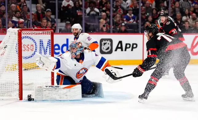 Ottawa Senators' Ridly Greig (71) watches his shot go into the net of New York Islanders goaltender Semyon Varlamov, front left, during the second period of an NHL hockey game in Ottawa, Ontario, Thursday, Oct. 15, 2026. (Justin Tang/The Canadian Press via AP)