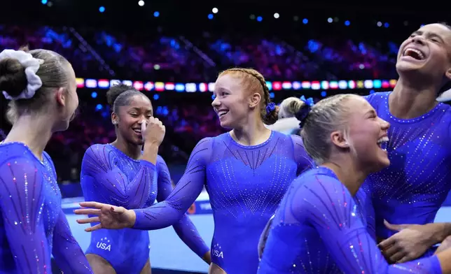 Dulcy Caylor, center, and her United States teammates react after completing their participation in the women's qualifications at the Artistic Gymnastics World Championships in Rotterdam, the Netherlands, Sunday, Oct. 18, 2026. (AP Photo/Francisco Seco)