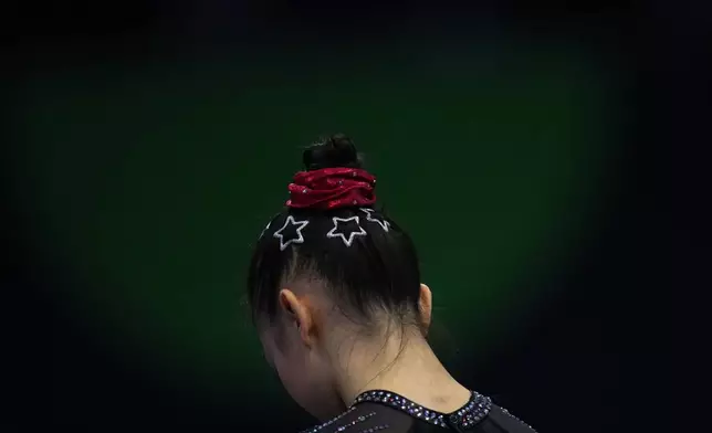 Ke Qinqin, of China, waits her turn to compete during the women's qualifications at the Artistic Gymnastics World Championships in Rotterdam, the Netherlands, Monday, Oct. 19, 2026. (AP Photo/Francisco Seco)