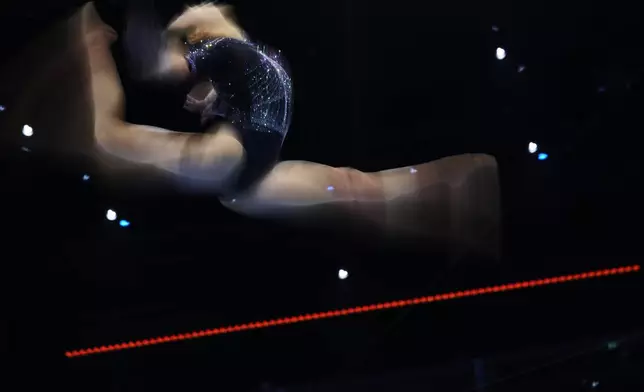 Qiu Qiyuan, of China, competes in the beam during the women's qualifications at the Artistic Gymnastics World Championships in Rotterdam, the Netherlands, Monday, Oct. 19, 2026. (AP Photo/Francisco Seco)