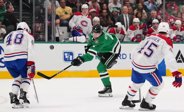 Dallas Stars defenseman Miro Heiskanen (4) has his shot blocked by Montréal Canadiens' Lane Hutson (48) as Alexandre Carrier (45) helps defend on the play in the first period of an NHL hockey game in Dallas, Thursday Oct. 29, 2026. (AP Photo/Tony Gutierrez)