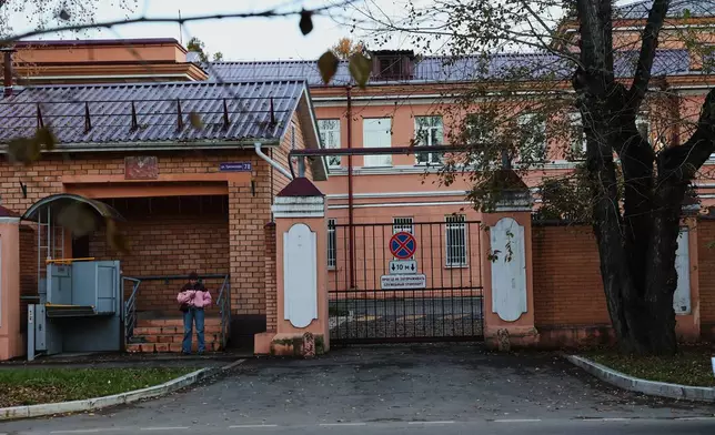 A pedestrian stands at the building of the Irkutsk Anti-Plague Research Institute of Siberia and the Far East in Irkutsk, Russi, on Wednesday, Oct. 7, 2026. (AP Photo)