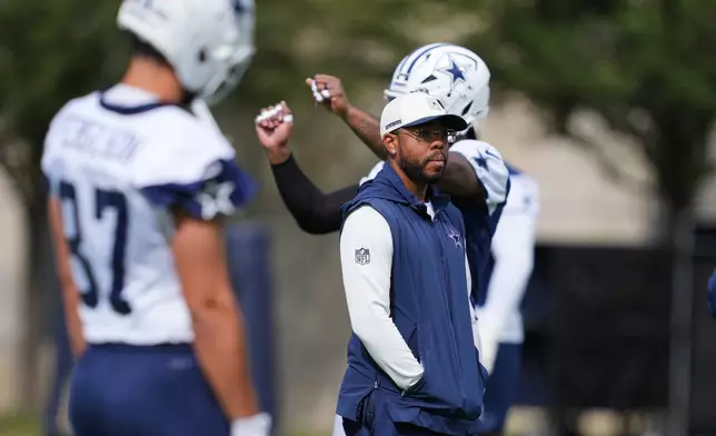 Christian Parker, the Dallas Cowboys defensive coordinator, watches players warm up before a practice at the NFL football team's headquarters, Friday, Oct. 16, 2026, in Frisco, Texas. (AP Photo/Tony Gutierrez)