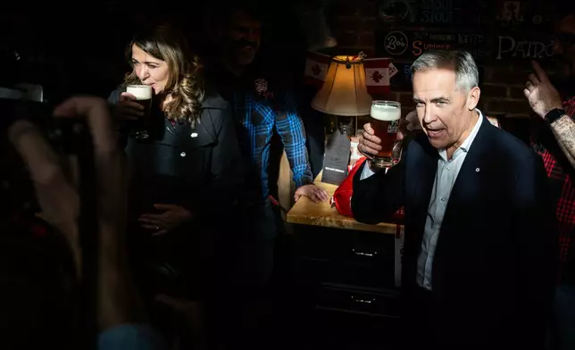 Prime Minister Mark Carney attends a national unity rally in Red Deer alongside Alberta Premier Danielle Smith on Friday, Oct. 16, 2026.. (John Ulan/The Canadian Press via AP)