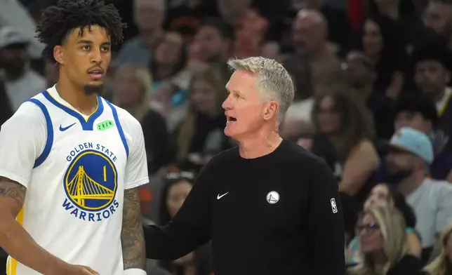Golden State Warriors head coach Steve Kerr, right, talks with Warriors forward Yaxel Lendeborg (1) during an NBA basketball game against the Phoenix Suns, Saturday, Oct. 24, 2026, in Phoenix. (AP Photo/Ross D. Franklin)