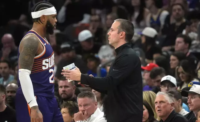 Phoenix Suns head coach Jordan Ott, right, talks with Suns forward Miles Bridges during an NBA basketball game against the Golden State Warriors, Saturday, Oct. 24, 2026, in Phoenix. (AP Photo/Ross D. Franklin)