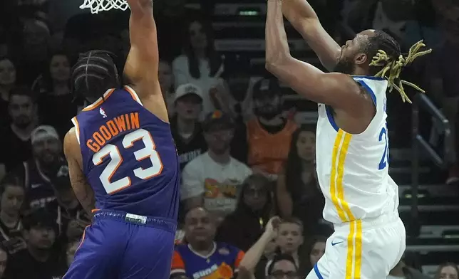 Golden State Warriors center Charles Bassey, right, shoots over Phoenix Suns guard Jordan Goodwin (23) during an NBA basketball game, Saturday, Oct. 24, 2026, in Phoenix. (AP Photo/Ross D. Franklin)