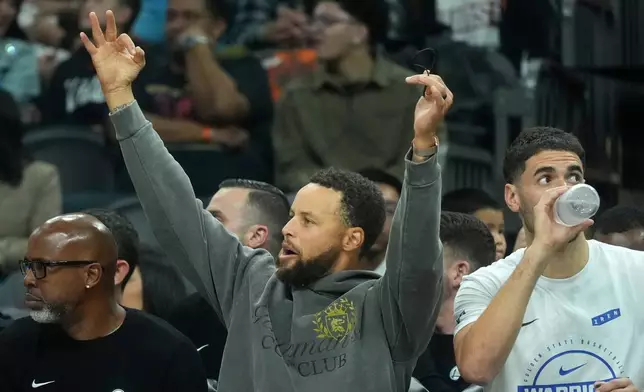 Golden State Warriors' Stephen Curry cheers after a 3-pointer against the Phoenix Suns during an NBA basketball game, Saturday, Oct. 24, 2026, in Phoenix. (AP Photo/Ross D. Franklin)
