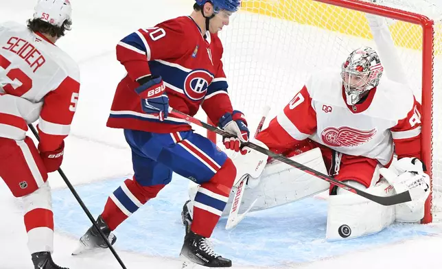 Montreal Canadiens' Juraj Slafkovsky (20) moves in on Detroit Red Wings goaltender Daniil Tarasov (80) during second period of an NHL hockey game in Montreal on Saturday, Oct. 10, 2026. (Graham Hughes/The Canadian Press via AP)