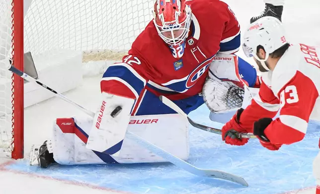 Montreal Canadiens goaltender Jacob Fowler (32) stops Detroit Red Wings' Alex DeBrincat (93) during second period of an NHL hockey game in Montreal on Saturday, Oct. 10, 2026. (Graham Hughes/The Canadian Press via AP)