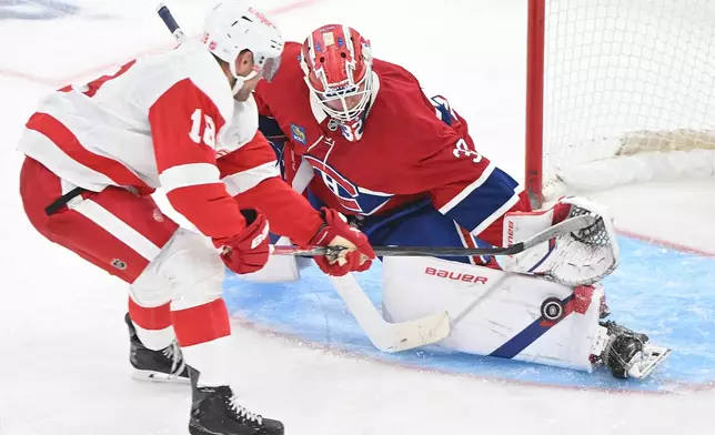 Montreal Canadiens goaltender Jacob Fowler (32) stops Detroit Red Wings' Andrew Copp (18) during third period of an NHL hockey game in Montreal on Saturday, Oct. 10, 2026. (Graham Hughes/The Canadian Press via AP)