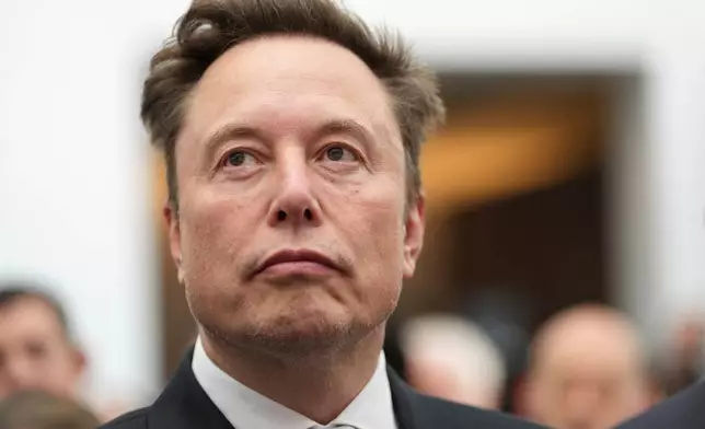 Elon Musk listens as President Donald Trump speaks during an event at the U.S. Institute of Peace, Thursday, Oct. 8, 2026, in Washington. (AP Photo/Julia Demaree Nikhinson)