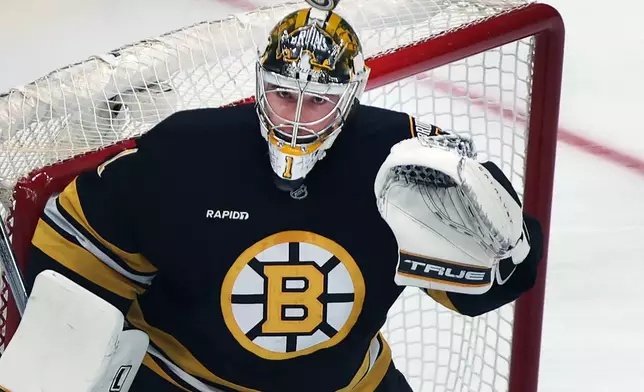 Boston Bruins goalie Jeremy Swayman watches the puck sailing over his head during the first period of an NHL hockey game against the San Jose Sharks, Saturday, Oct. 24, 2026, in Boston. (AP Photo/Jim Davis)
