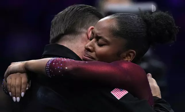 Skye Blakely, of the United States, hugs her coach after competing in the floor exercise during the women's all-around final at the Artistic Gymnastics World Championships in Rotterdam, the Netherlands, Friday, Oct. 23, 2026. (AP Photo/Francisco Seco)