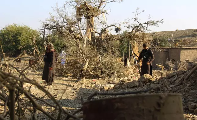 Taliban security officers inspect the scene of what Taliban officials said were Pakistani airstrikes in Khost province, Afghanistan, Thursday, Sept. 24, 2026. (AP Photo/Saifullah Zahir)