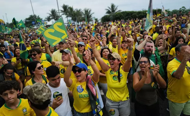 Supporters of opposition presidential candidate Sen. Flavio Bolsonaro cheer during his final campaign rally a day ahead of the presidential runoff election in Rio de Janeiro, Saturday, Oct. 24, 2026. (AP Photo/Lucas Landau)