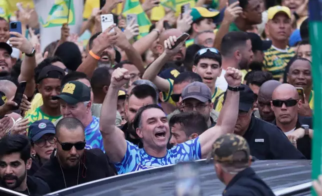 Opposition presidential candidate Sen. Flavio Bolsonaro, center, leaves after his final campaign rally a day ahead of the presidential runoff election in Rio de Janeiro, Saturday, Oct. 24, 2026. (AP Photo/Bruna Prado)