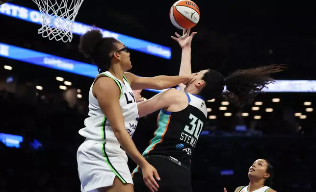 Minnesota Lynx guard Olivia Miles fouls New York Liberty forward Breanna Stewart (30) during the second half of Game 2 of a WNBA basketball first-round playoff series, Tuesday, Sept. 29, 2026, in New York. (AP Photo/Heather Khalifa)