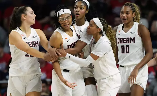 Atlanta Dream guard Allisha Gray, second from left, is held back by teammates after no foul was called against the Washington Mystics during the second half in Game 2 of a WNBA basketball first-round playoff series, Wednesday, Sept. 30, 2026, in Washington. (AP Photo/Stephanie Scarbrough)