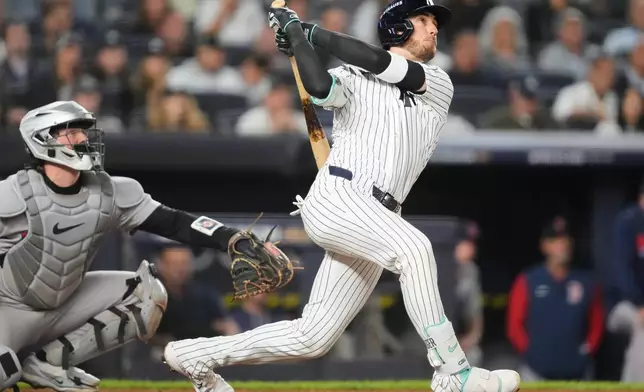 New York Yankees' Cody Bellinger follows through on a three-run home run during the sixth inning against the Boston Red Sox in Game 2 of baseball's American League Wild Card Series, Wednesday, Sept. 30, 2026, in New York. (AP Photo/Yuki Iwamura)