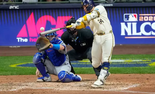 Milwaukee Brewers catcher William Contreras (24) connects for an RBI base hit during the sixth inning of Game 2 of baseball's National League Championship Series between the Milwaukee Brewers and the Los Angeles Dodgers, Monday, Oct. 12, 2026, in Milwaukee. (AP Photo/Kayla Wolf)