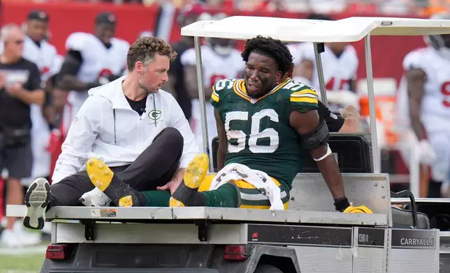 Green Bay Packers linebacker Edgerrin Cooper (56) is removed from the field after sustaining an injury during the second half of an NFL football game against the Tampa Bay Buccaneers in Tampa, Fla., Sunday, Oct. 4, 2026. (AP Photo/Chris O'Meara)