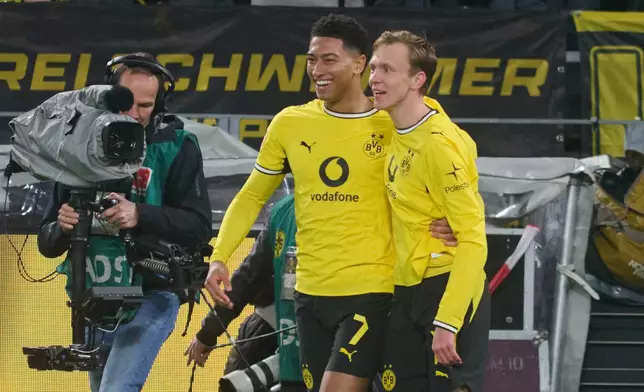 Dortmund's Maximilian Beier, right, celebrates with Jobe Bellingham after scoring the opening goal during the German Bundesliga soccer match between Borussia Dortmund and Eintracht Frankfurt, in Dortmund, Germany, Saturday, Oct. 24, 2026. (Bernd Thissen/dpa via AP)