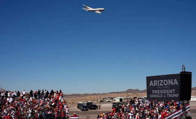 Air Force One with President Donald Trump aboard flys past before landing for a campaign rally at the Laughlin Bullhead International Airport, Wednesday, Oct. 14, 2026, in Bullhead City, Ariz. (AP Photo/John Locher)