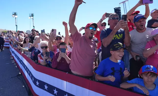 People cheer as President Donald Trump arrives at Laughlin Bullhead International Airport for a campaign rally, Wednesday, Oct. 14, 2026, in Bullhead, Ariz. (AP Photo/Alex Brandon)