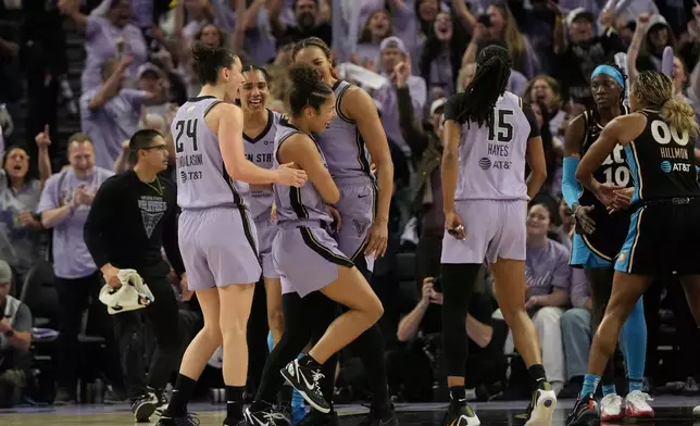 Golden State Valkyries guard Veronica Burton, foregound middle, celebrates with forward Cecilia Zandalasini (24), forward Gabby Williams, second from left, center Kiah Stokes, middle rear, and guard Tiffany Hayes (15) during the second half of Game 5 of the WNBA basketball finals against the Atlanta Dream, Monday, Oct. 26, 2026, in San Francisco. (AP Photo/Jeff Chiu)