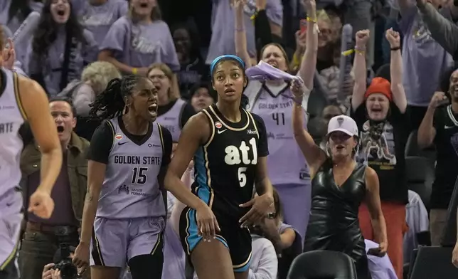 Golden State Valkyries guard Tiffany Hayes (15) celebrates after scoring next to Atlanta Dream forward Angel Reese (5) during the second half of Game 5 of the WNBA basketball finals, Monday, Oct. 26, 2026, in San Francisco. (AP Photo/Jeff Chiu)