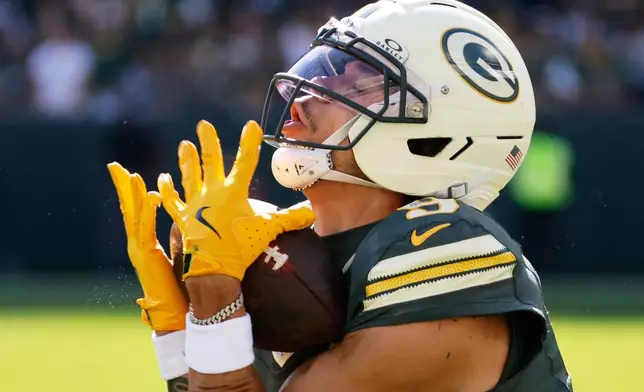 Green Bay Packers' Christian Watson catches a touchdown pass during the first half of an NFL football game against the Chicago Bears in Green Bay, Wis., Sunday, Oct. 11, 2026. (AP Photo/Mike Roemer)