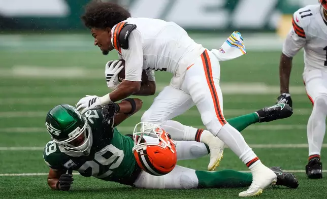 Cleveland Browns wide receiver Kc Concepcion loses his helmet as he is tackled by New York Jets safety Minkah Fitzpatrick (29) during the first half of an NFL football game, Sunday, Oct. 11, 2026, in East Rutherford, N.J. (AP Photo/Yuki Iwamura)