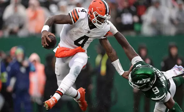 Cleveland Browns quarterback Deshaun Watson (4) runs from New York Jets defensive end Will McDonald IV (9) during the second half of an NFL football game, Sunday, Oct. 11, 2026, in East Rutherford, N.J. (AP Photo/Adam Hunger)