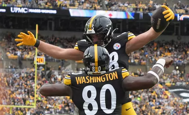 Pittsburgh Steelers tight end Pat Freiermuth (88) celebrates a touchdown catch with tight end Darnell Washington (80) against the Indianapolis Colts during the first half of an NFL football game in Pittsburgh, Sunday, Oct. 11, 2026. (AP Photo/Gene J. Puskar)