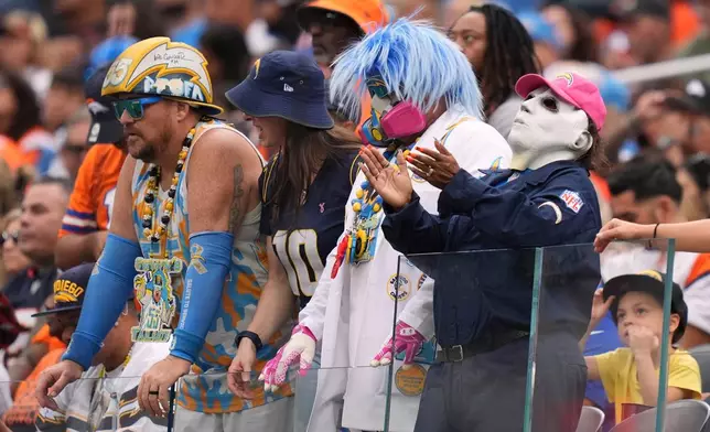 Fans watch during the first half of an NFL football game between the Los Angeles Chargers and the Denver Broncos, Sunday, Oct. 11, 2026, in Inglewood, Calif. (AP Photo/Scott Strazzante)