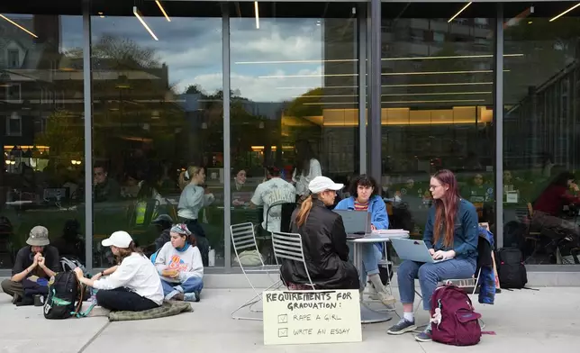 Students and attendees sit during a sit-in protest at Cornell University, Wednesday, Oct. 7, 2026, in Ithaca, N.Y. (AP Photo/Matt Burkhartt)
