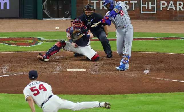 Los Angeles Dodgers left fielder Teoscar Hernández (37) hits a single on a pitch by Atlanta Braves pitcher Tyler Mahle (54) during the seventh inning in Game 4 of baseball's National League Division Series, Wednesday, Oct. 7, 2026, in Atlanta. (AP Photo/Colin Hubbard)